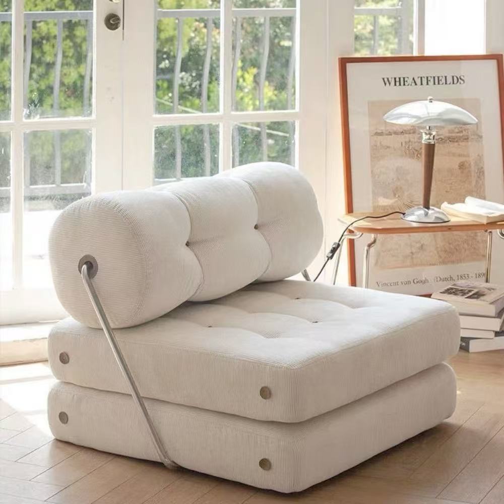 Multifunctional foldable sofa bed in elegant boucle fabric—convertible futon-style sleeper for cozy small apartments and living rooms.