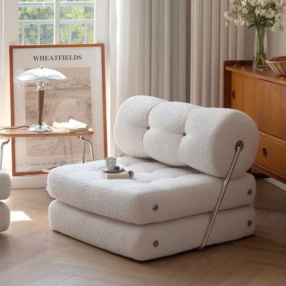 Multifunctional foldable sofa bed in elegant boucle fabric—convertible futon-style sleeper for cozy small apartments and living rooms.