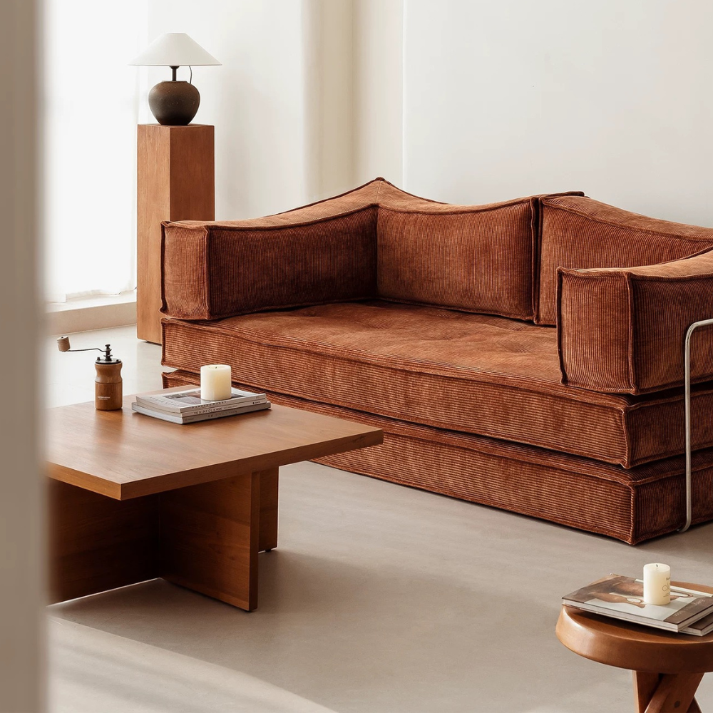 Compressed modular sofa bed in brown corduroy or yellow linen – deep seat, convertible, space-saving, eco-friendly fabric, texture close-up, 2025 trend