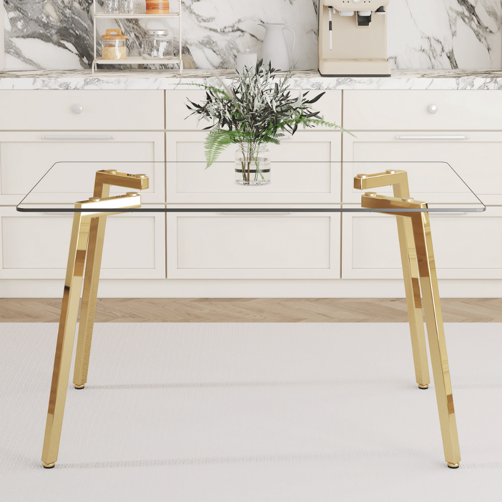 Modern glass dining table with clear tempered top and Z‑shaped metal legs in silver or gold, sleek minimalist design, easy clean, space‑saving.