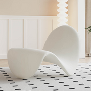 Homiyu sculptural wave lounge chair with soft sherpa or suede upholstery, modern curved silhouette as a statement art piece in living space.
