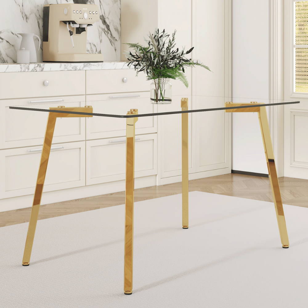 Modern glass dining table with clear tempered top and Z‑shaped metal legs in silver or gold, sleek minimalist design, easy clean, space‑saving.