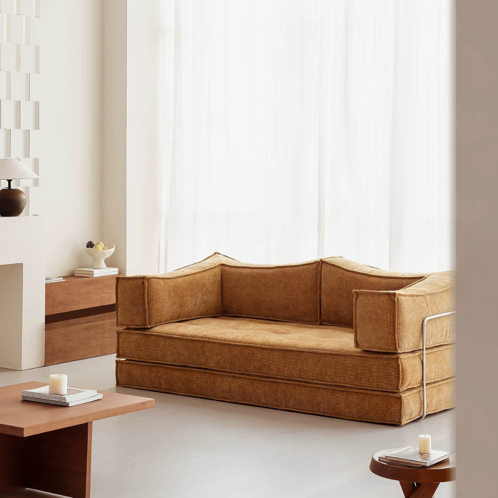 Compressed modular sofa bed in brown corduroy or yellow linen – deep seat, convertible, space-saving, eco-friendly fabric, texture close-up, 2025 trend.