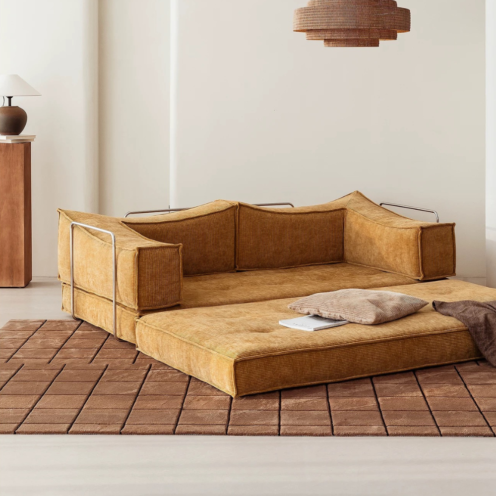 Compressed modular sofa bed in brown corduroy or yellow linen – deep seat, convertible, space-saving, eco-friendly fabric, texture close-up, 2025 trend.